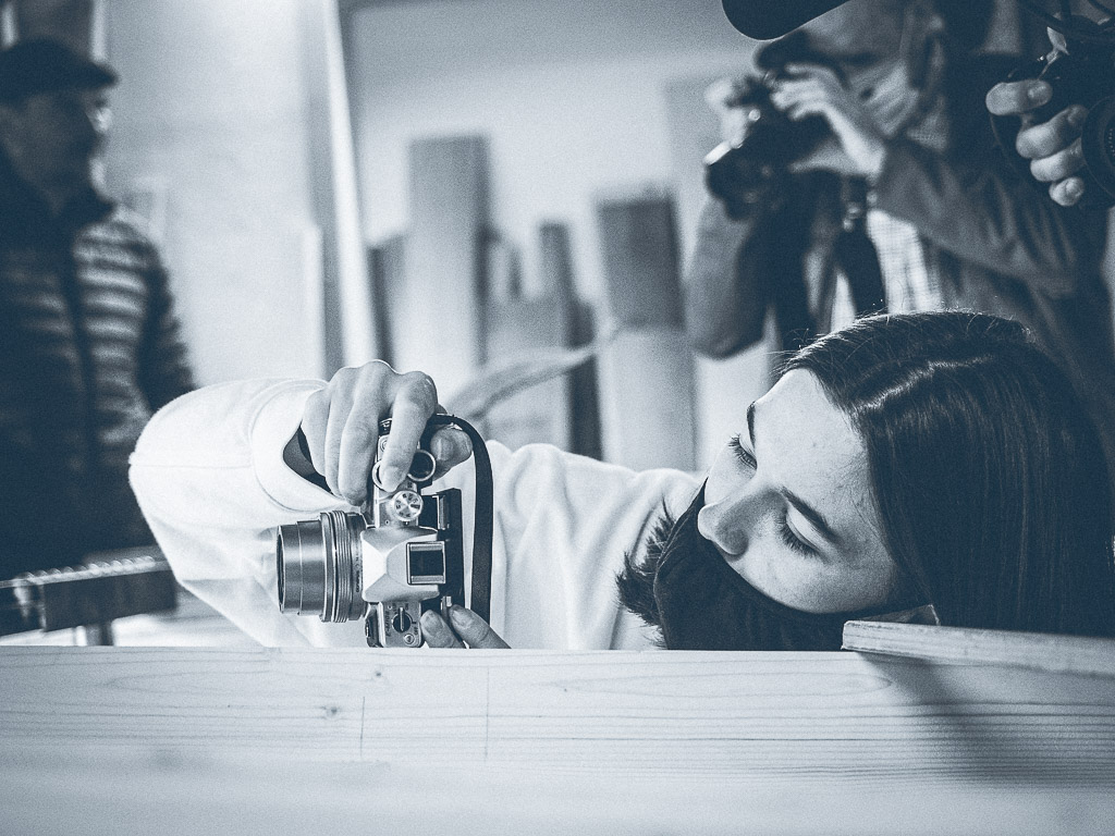 Eine Teilnehmerin am Fotokurs Donau Oberösterreich 2020 von Fotograf Peter Podpera beim Fotografieren in der Werkstatt eines Zillenbauers